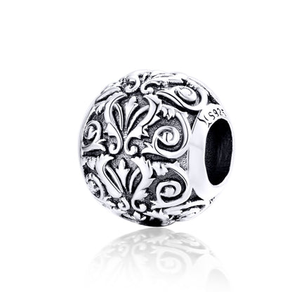 Sterling silver charm bead with retro flower swirl texture and dark center opening