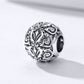 Sterling silver flower-texture charm bead with ornate swirls and dark side hole