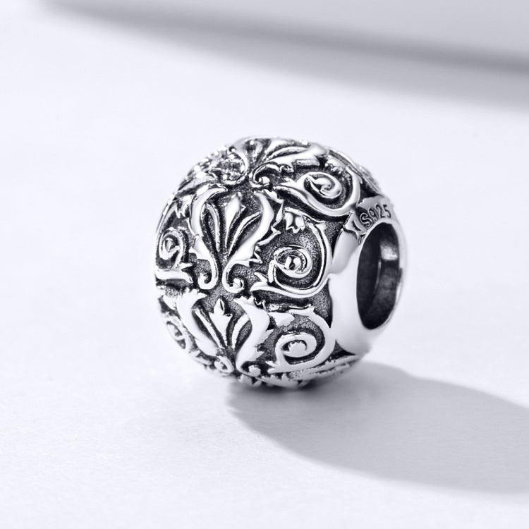 Sterling silver flower-texture charm bead with ornate swirls and dark side hole