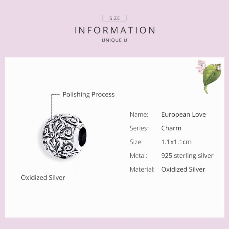 Oxidized silver charm bead with engraved retro flower swirls and dark inner opening