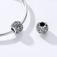 Silver snake-chain bracelet with ornate flower-pattern charm beads