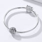 Snake-chain bracelet with retro flower-texture charm bead and a crystal top charm