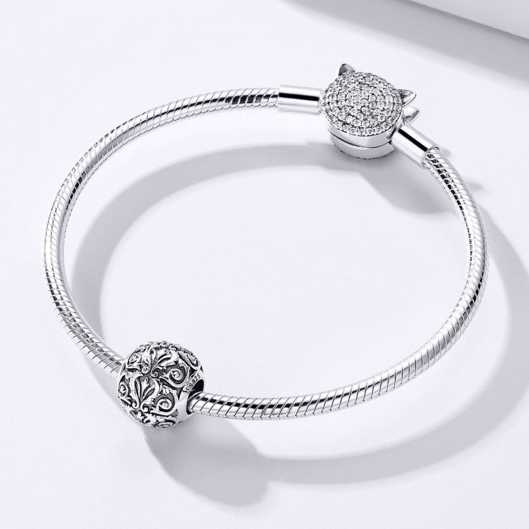 Snake-chain bracelet with retro flower-texture charm bead and a crystal top charm