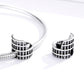 Pair of sterling silver Colosseum charm beads with oxidized facade and rounded ends