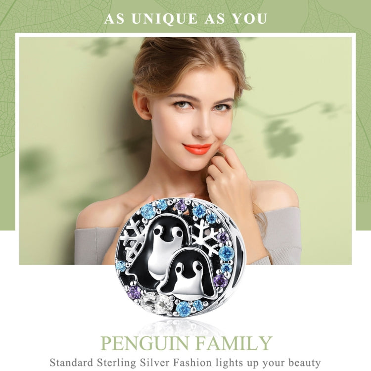 Sterling silver penguin charm bracelet featuring two penguins and blue/purple stone details
