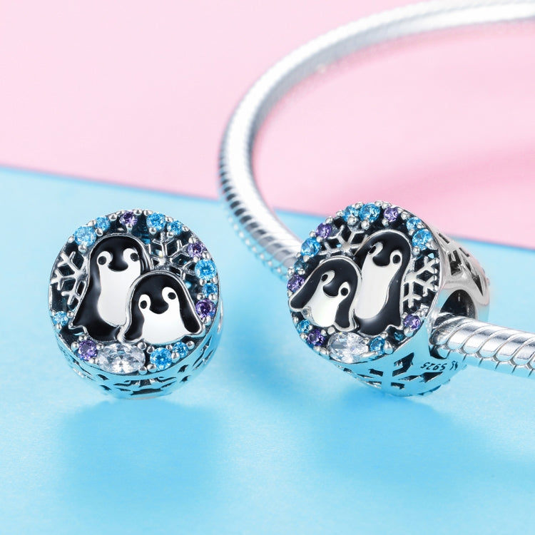 Two sterling silver penguin charm beads with blue and purple stone accents and enamel