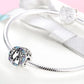 Sterling silver bracelet with penguin charm bead and blue/purple CZ stone border