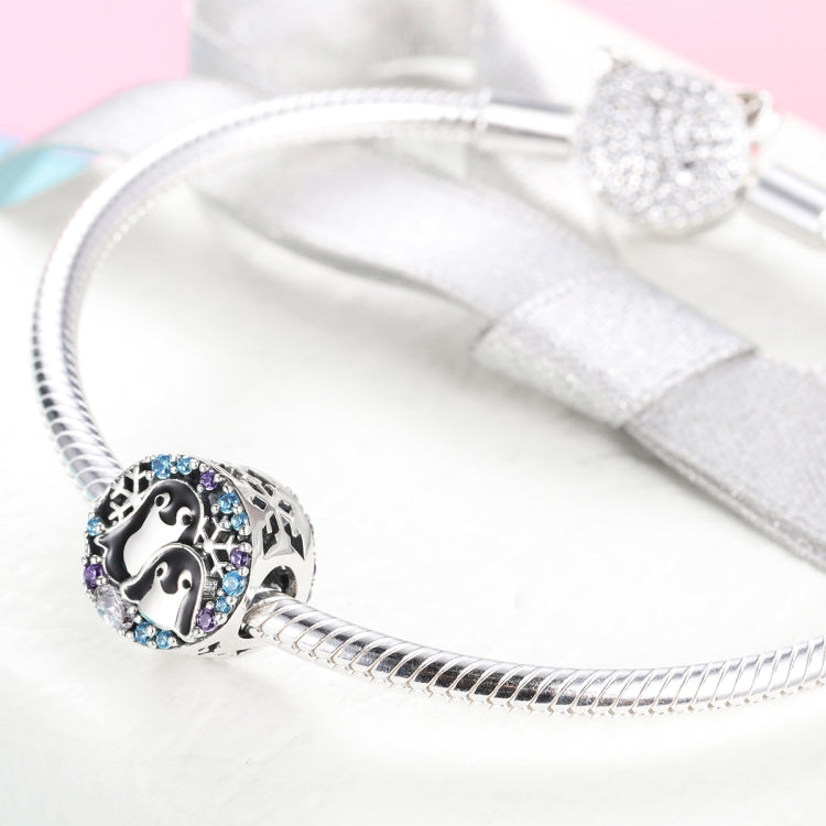 Sterling silver bracelet with penguin charm bead and blue/purple CZ stone border
