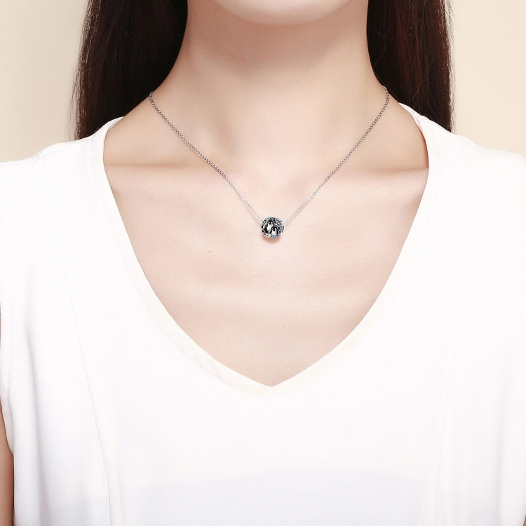 Sterling silver penguin charm bracelet worn on a necklace-length chain
