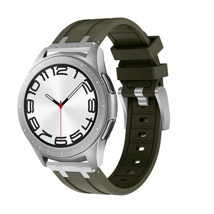Olive silicone watch band shown on a silver watch with a ridged strap and buckle.
