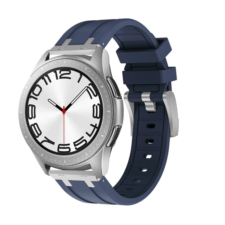 Navy silicone watch band shown on a silver watch with a ridged strap and buckle.