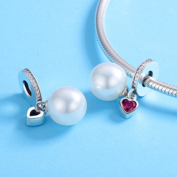 Silver charm bracelet with white pearl beads and small red heart dangle