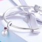 Silver bracelet charm with small red heart gem and white pearl bead
