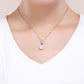 Wearing silver necklace pendant with red heart gem and white pearl drop