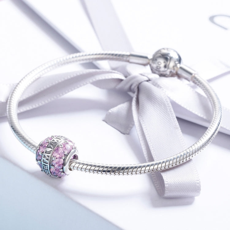 Sterling silver charm bracelet with pink and purple bead accents