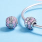 Sterling silver charm bead with pink and purple crystal accents, one loose and one on bracelet