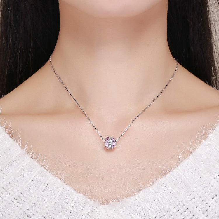 Pink-stone sterling silver pendant necklace with a small teardrop-like charm