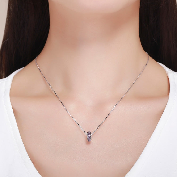 Sterling silver necklace with a small pink stone charm pendant on a thin chain
