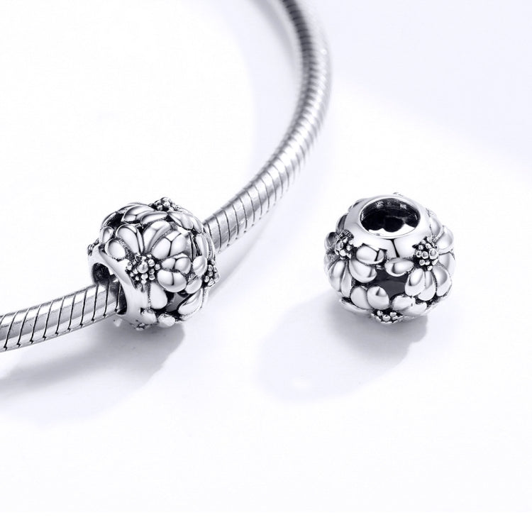Sterling silver daisy charm bead and round bead spacer with oxidized floral detailing