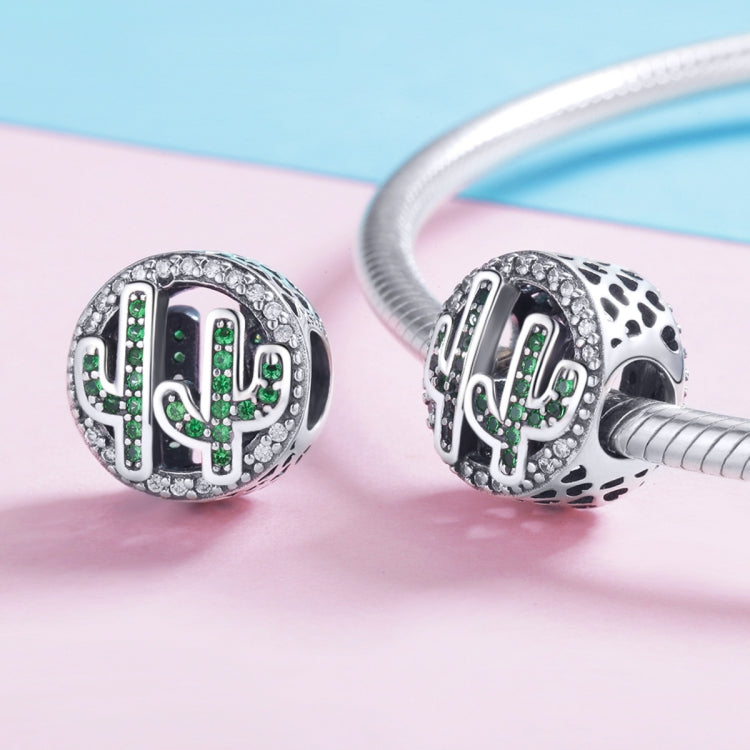 Two sterling silver cactus charm beads with green crystal inlay on a bracelet