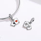 Snake-chain bracelet with red-heart A card charm and second silver charm with floral design