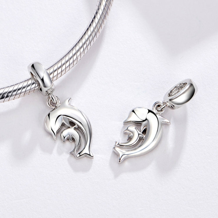 Silver-tone dolphin charm pendants on chain bracelet with round connector caps