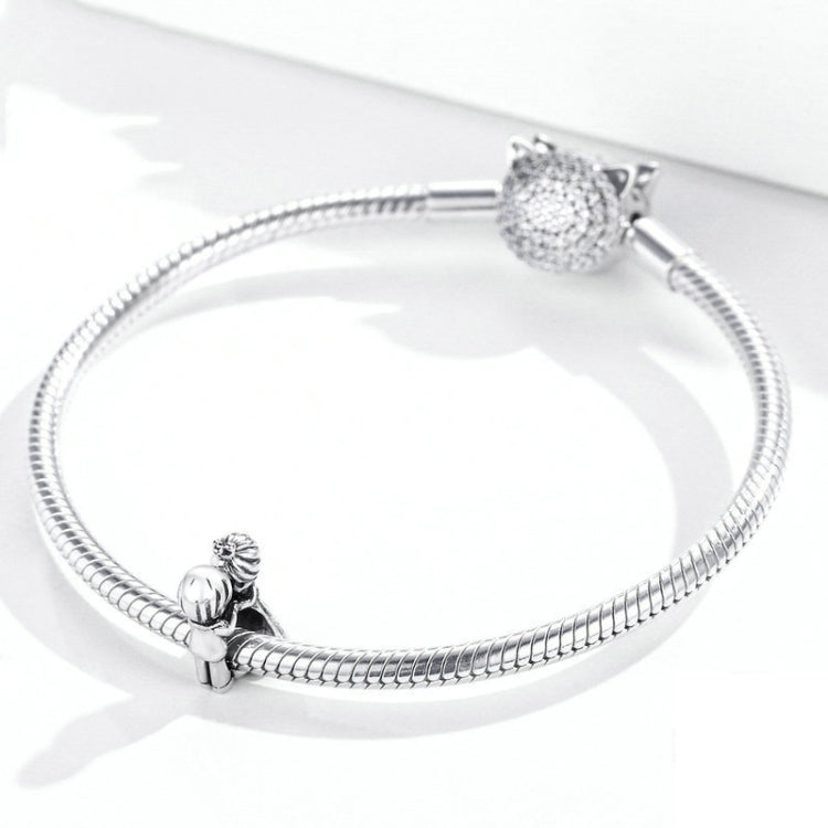 Sterling silver snake chain bracelet with textured round bead and small charm