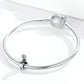 Sterling silver snake chain bracelet with left flower charm and right round bead