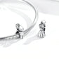 Sterling silver snake chain with girl and boy charms, close-up