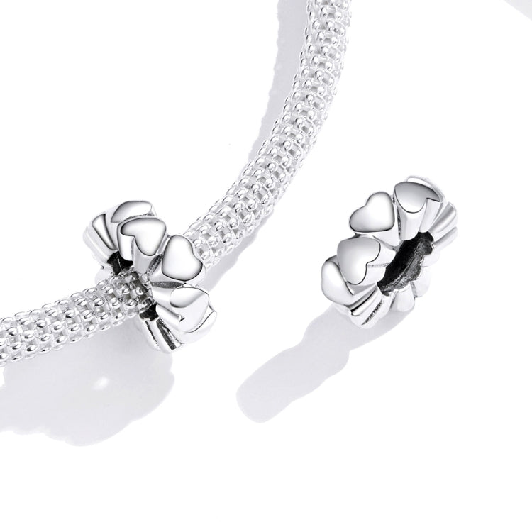 Silver heart charm bead with heart-shaped links and dark oxidized center on chain