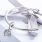 Sterling silver heart charm bead on a braided bracelet with infinity knot design