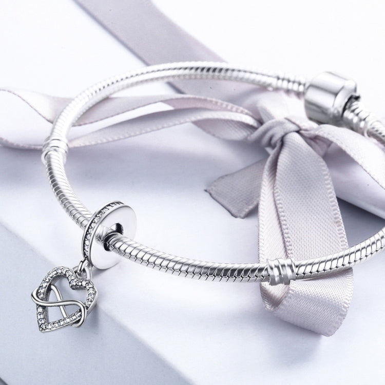 Sterling silver heart charm bead on a braided bracelet with infinity knot design
