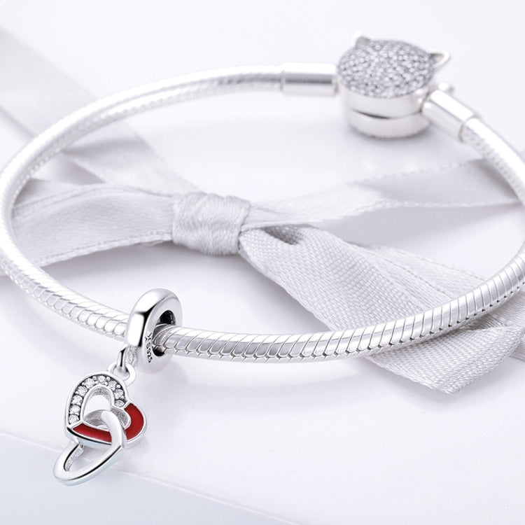 Silver charm bracelet with heart-to-heart pendant, red enamel, and clip clasp