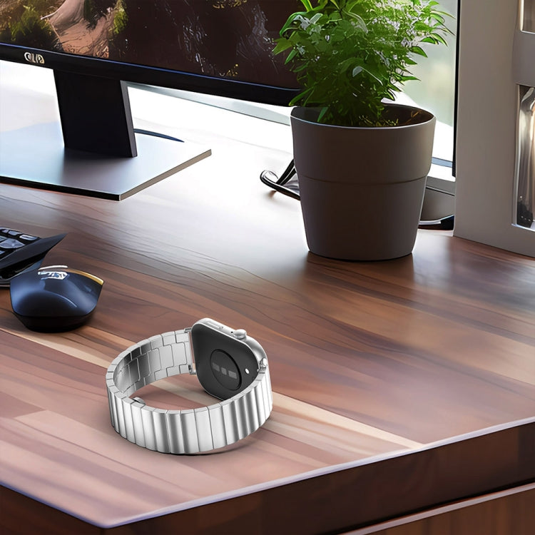 Silver stainless steel watch band attached to a smartwatch, shown from the back