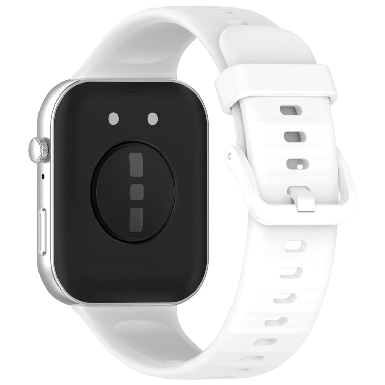 White silicone sports watch band attached to a smartwatch, shown from the back