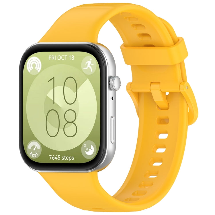 Yellow silicone sports watch band attached to a smartwatch, shown from the display side