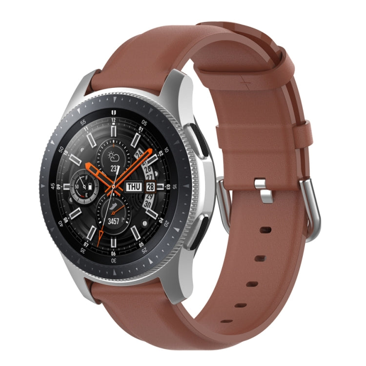 Brown watch strap with round tail buckle and silver clasp, perforated band