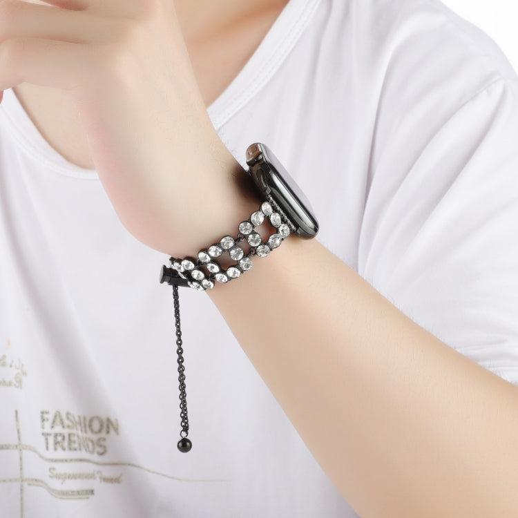 Black rhinestone bracelet watch band worn on wrist with dangling chain clasp