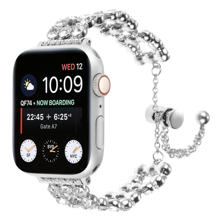 Silver metal watch band with crystal accents and adjustable chain clasp on a smartwatch.