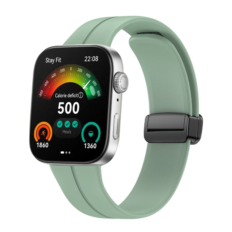 Grey-green silicone watch band with black magnetic buckle shown on a smartwatch