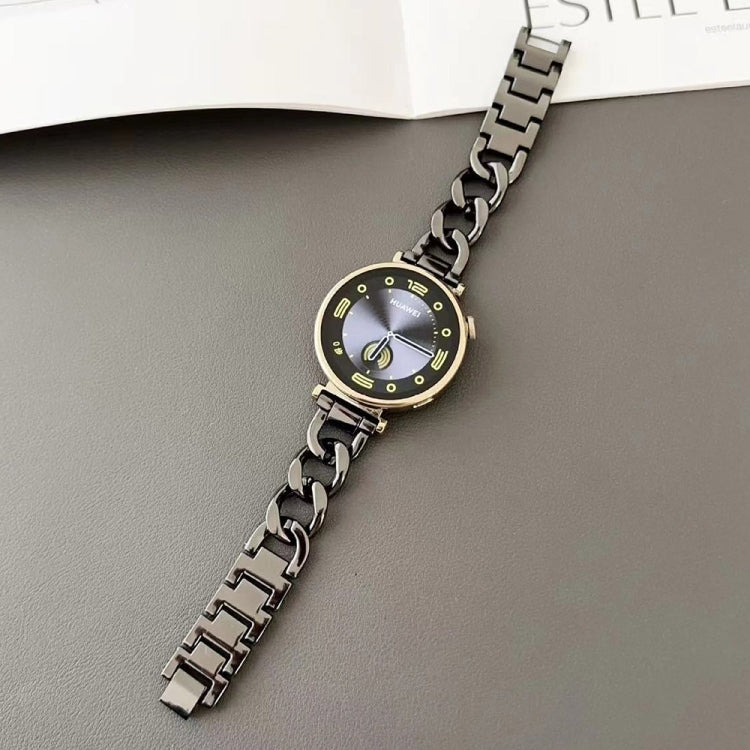 Black metal chain watch band fitted to a round watch, shown lying flat.