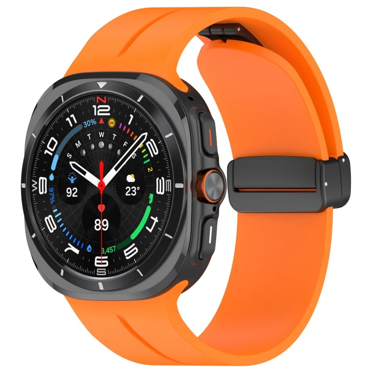 Orange silicone magnetic folding buckle watch band attached to a smartwatch
