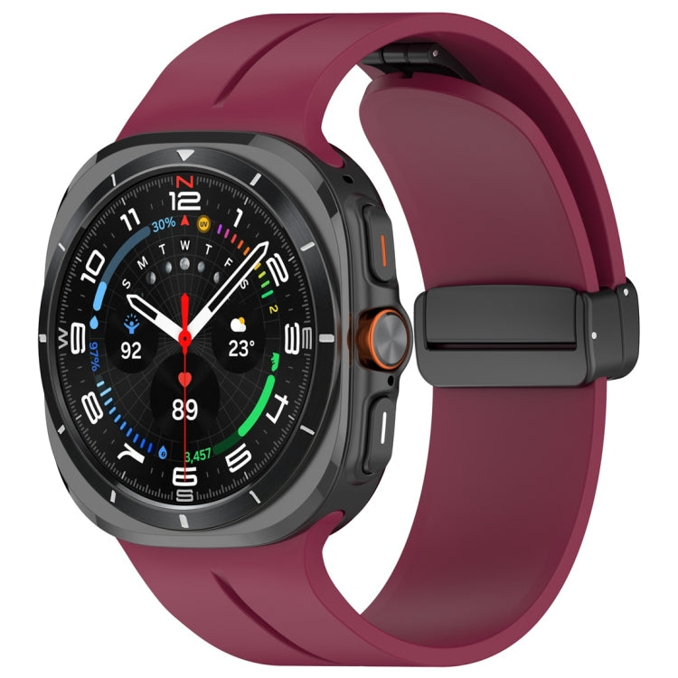 Wine red silicone magnetic folding buckle watch band attached to a smartwatch