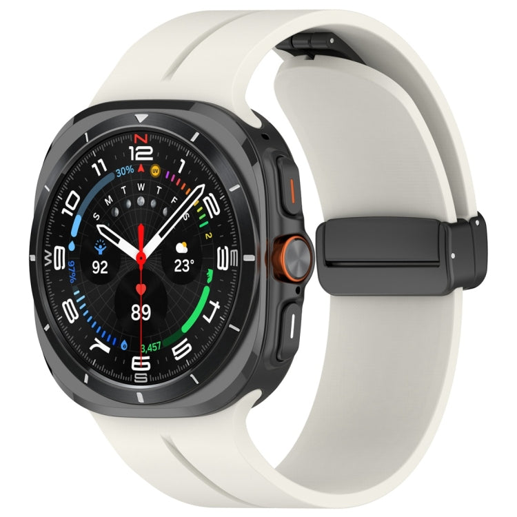 Cream silicone watch band with magnetic folding clasp attached to a dark smartwatch