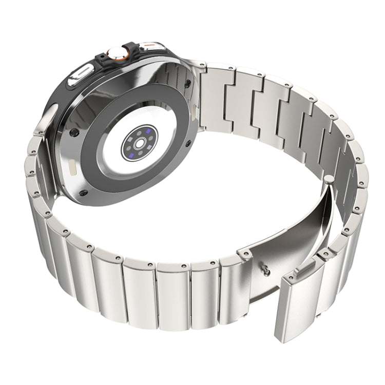 Silver titanium watch band shown open from the back, revealing its linked clasp