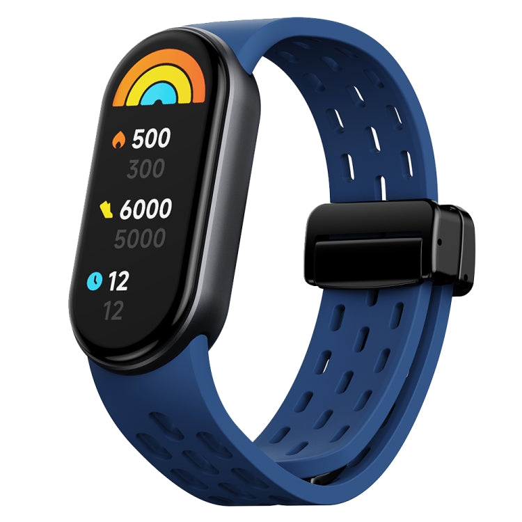 Dark blue perforated silicone watch band with black magnetic buckle and fitness tracker