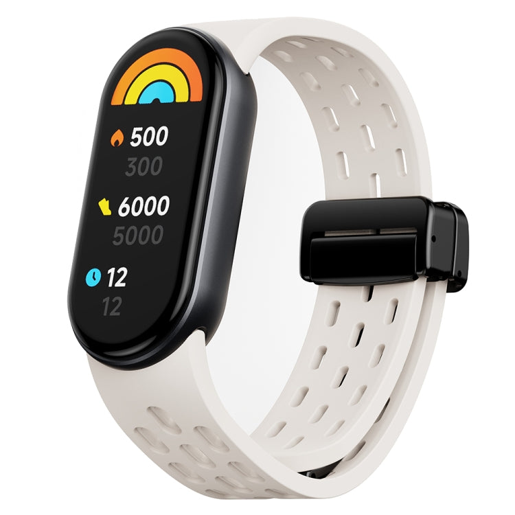 White perforated silicone watch band with black magnetic buckle and fitness tracker