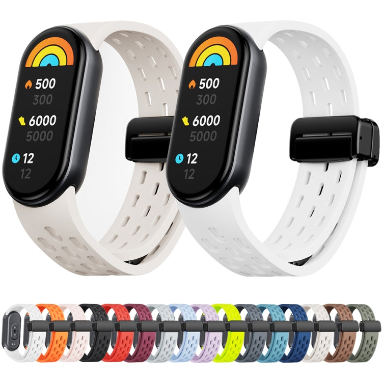 Two pale watch bands with magnetic buckles, shown with a row of available colors