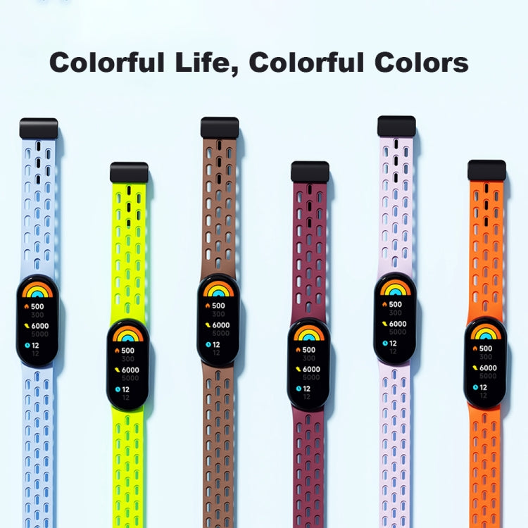 Perforated watch bands in six colors, each fitted with a black fitness tracker