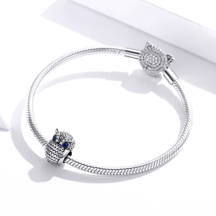 Silver charm bracelet with an owl bead and blue CZ eyes, plus sparkling clasp